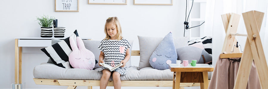 little blonde girl sitting on a couch