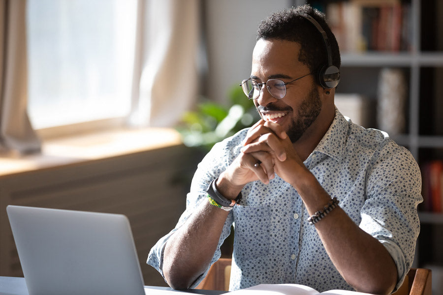 man in glasses on laptop