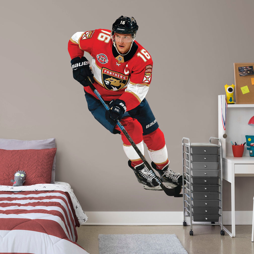 Large Athlete + 2 Team Decals (11"W x 16"H) NHL fans and Panthers fanatics alike love Aleksander Barkov, the clutch captain from Florida, and now you can bring his skill to life in your own home! Seen here in action on the ice, this durable and bold wall decal will make the perfect addition to your bedroom, office, fan room, or any spot in your house!